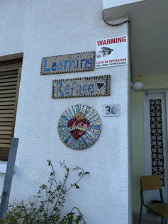 a sign reading Learning Refuge next to a doorway