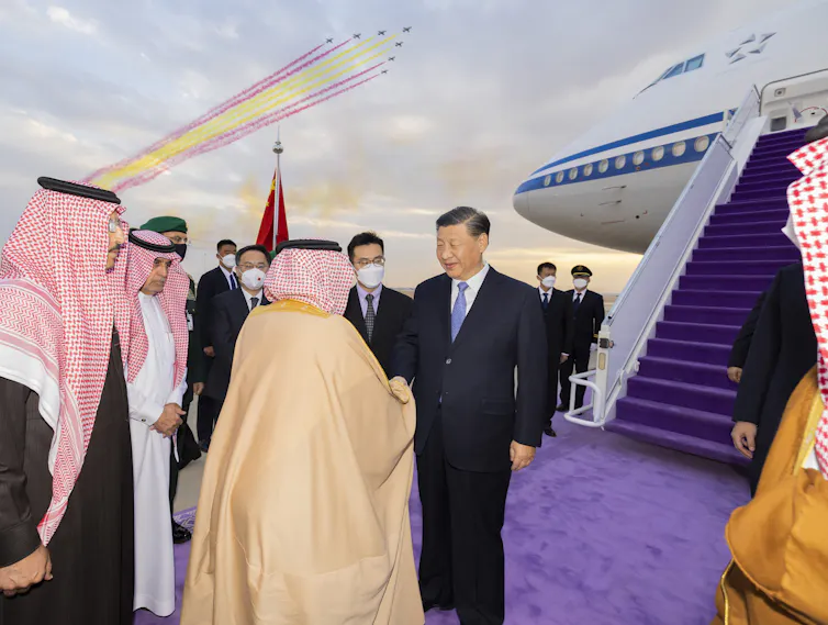 Xi Jinping being greeted at Riyadh airport by members of the Saudi royal family.