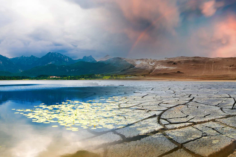 dry earth and lake, cloudy sky