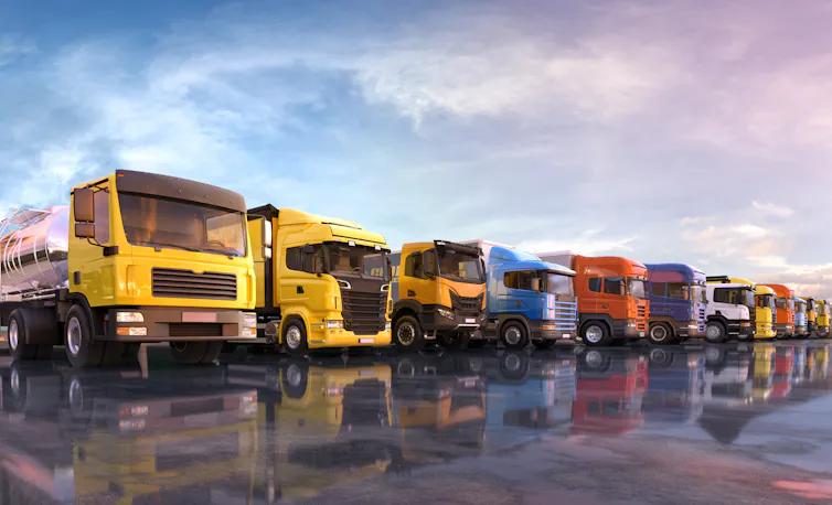 Row of parked up colourful lorries.