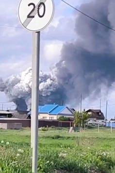 Smoke rising from low rise buildings.