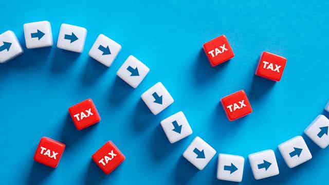 Illustration of arrows plotting path through blocks mark tax to show tax avoidance.