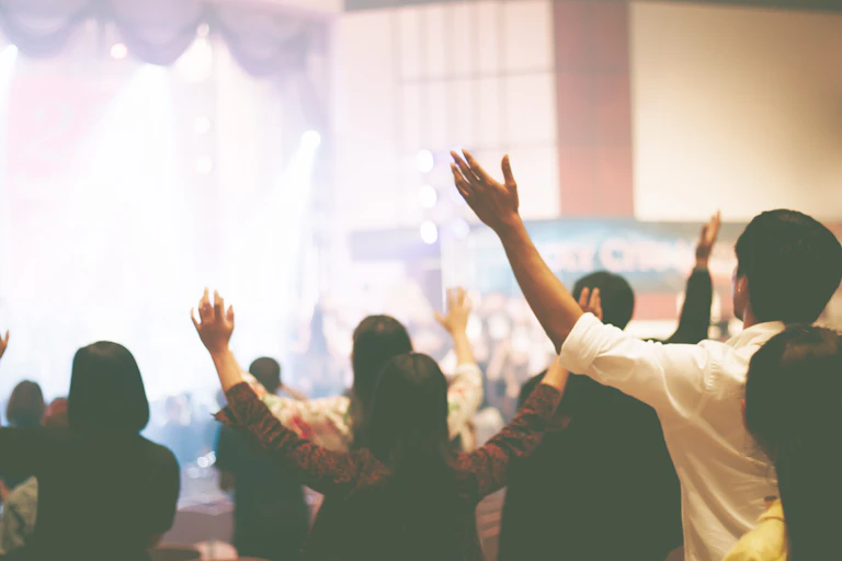Worshippers with their hands raised during a service
