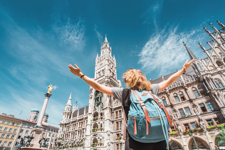 Young woman with rucksack in front of New Town Hall in Munich