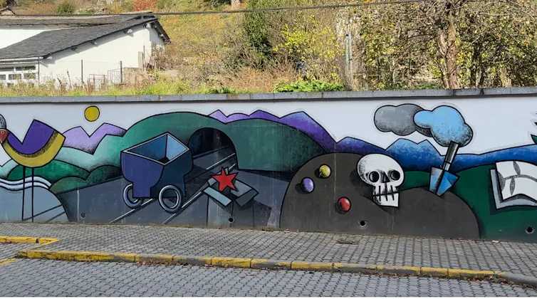 Este mural, obra del artista Manuel Sierra y ubicado en la localidad de Villablino (León), es una forma de expresión que, a través de metáforas visuales, representa lo que supuso la minería del carbón para los valles de comarcas como Laciana.