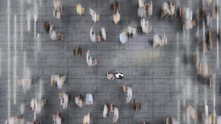 People scurrying across a street.