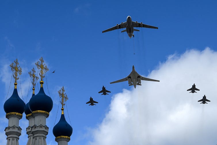 A number of aircraft fly over a Russian skyline.