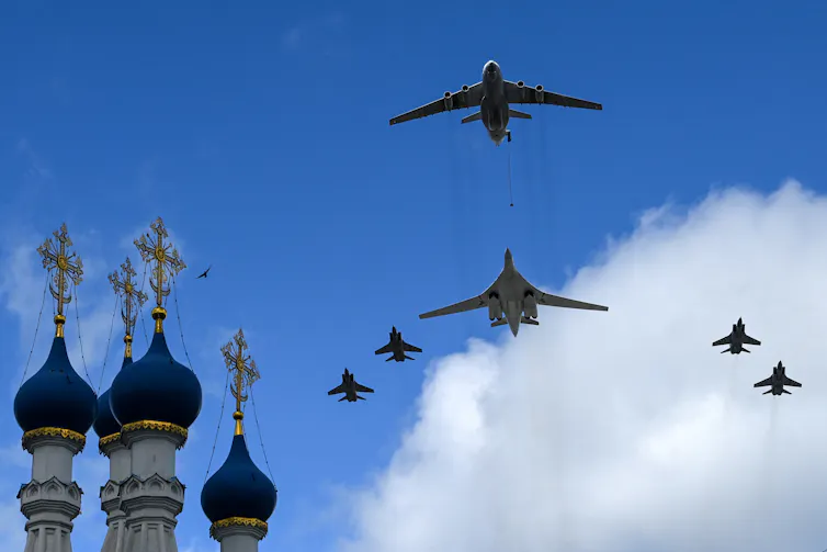 A number of aircraft fly over a Russian skyline.