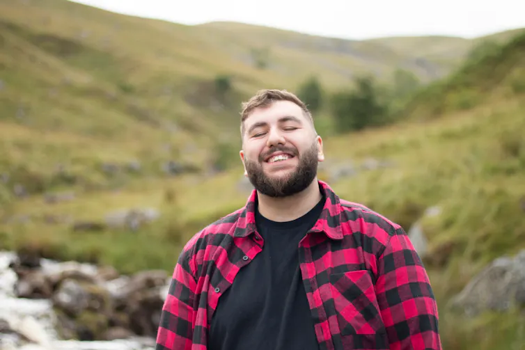 Man smiling in nature.