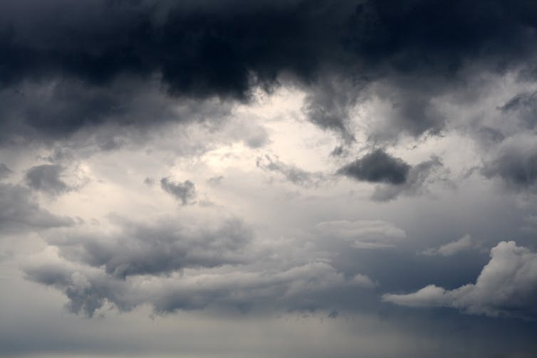 a dark storm-cloudy sky, with a little bit of brightness showing