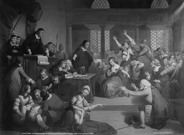 A painting depicts a courtroom with dozens of people as a judge looks on from a bench.