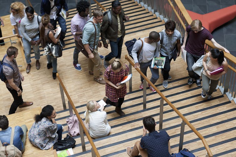 An elevated view of college students walking up stairs.
