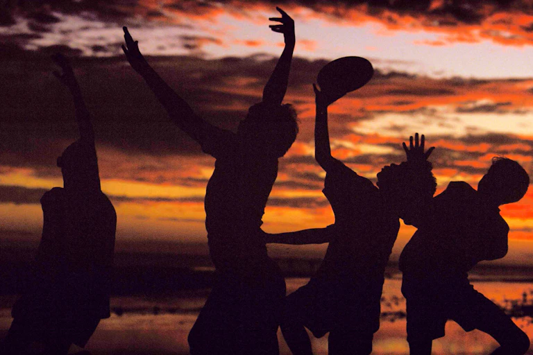 Aboriginal boys play a game of Australian rules football on a beach in far North Queensland.