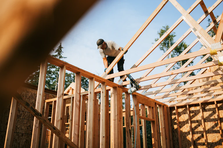 Builder framing a house.