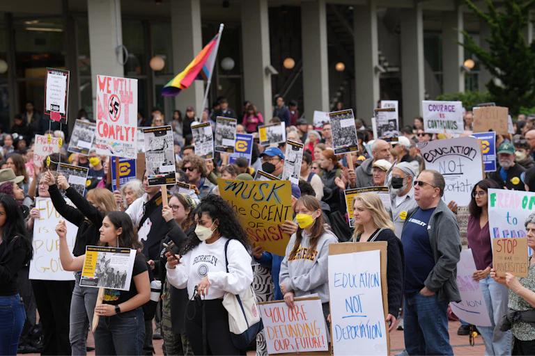 Students, professors and staff protest the dictates of President Trump on the university