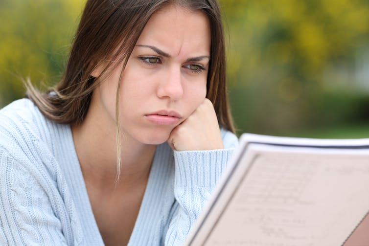 Woman frowns at document