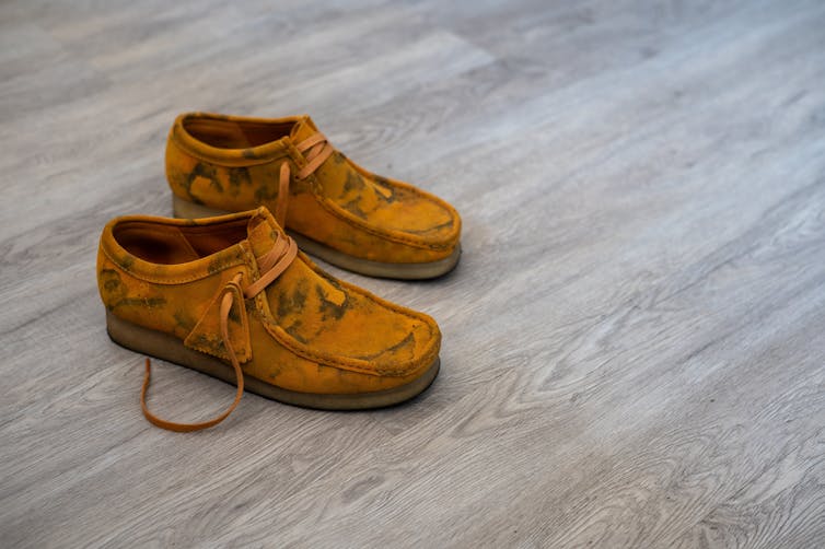 a pair of tan clarks wallabee shoes