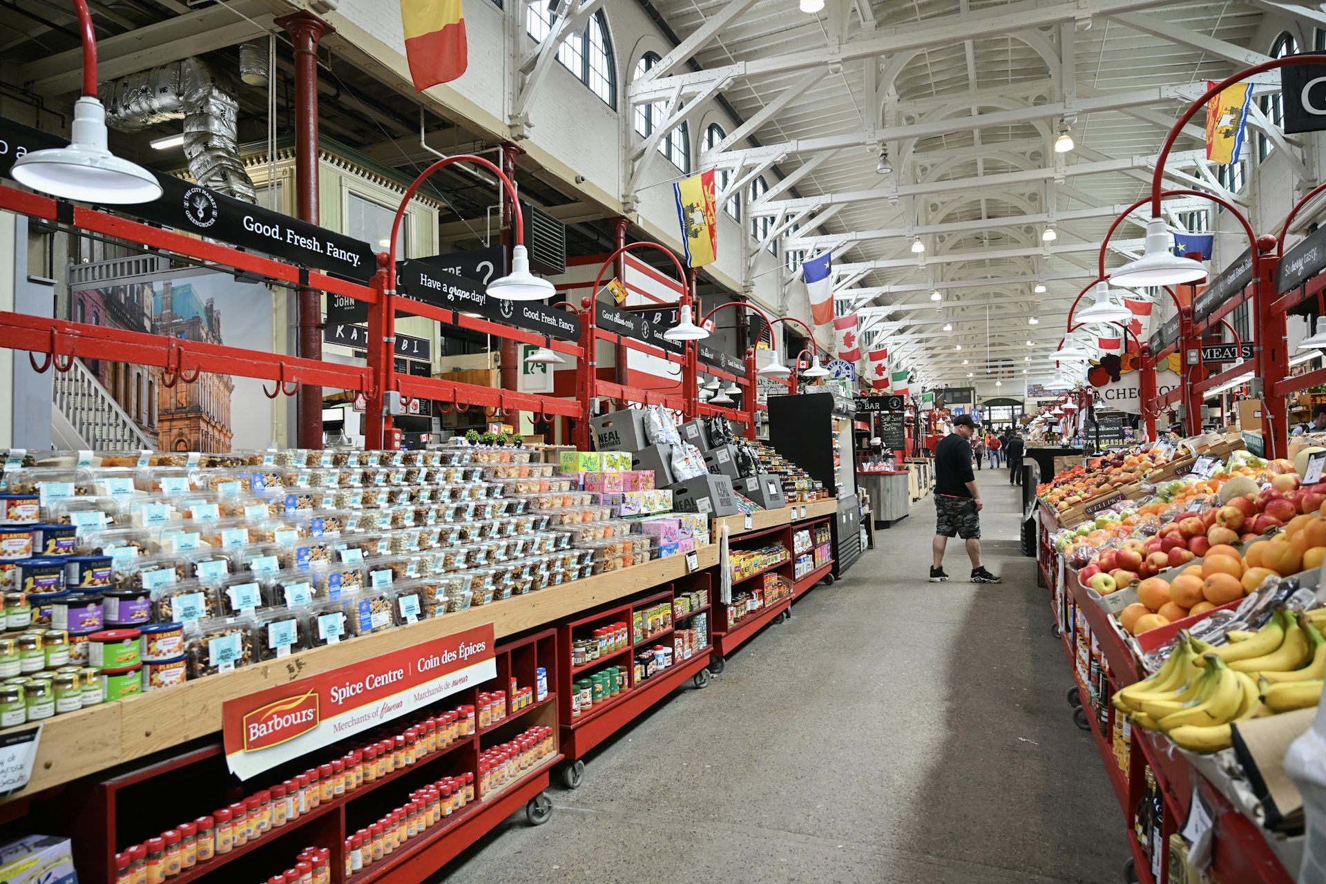A person seen near the produce section of a grocer.
