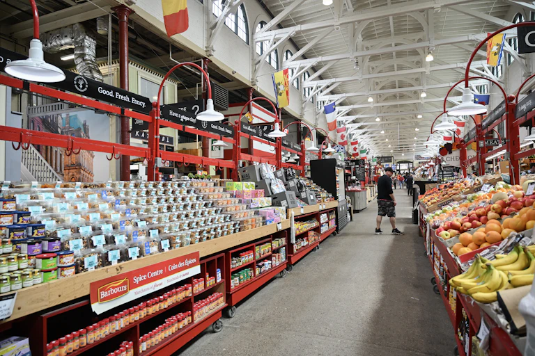 A person seen near the produce section of a grocer.