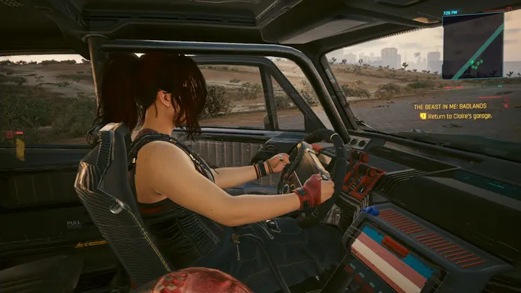 In-game screenshot of Claire Russell during her quest line: The Beast in Me. The interior of Claire’s vehicle, showing the transgender pride flag painted across her centre stack.