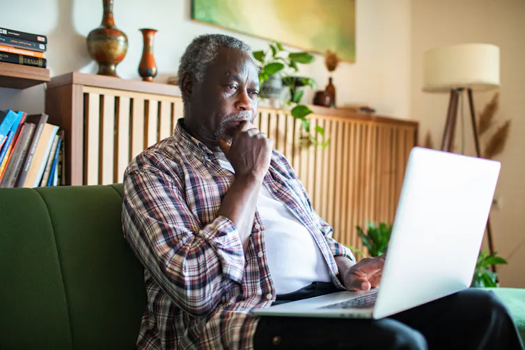 A senior man on a laptop.