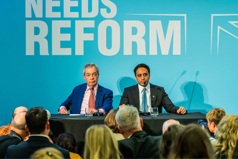 Nigel Farage and Zia Yusuf giving a press conference.