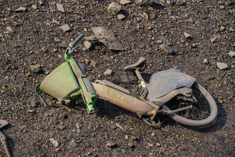 An abandoned Lime e-bike in the ground