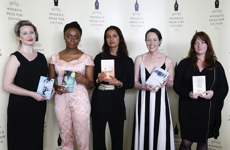 Four women holding books.