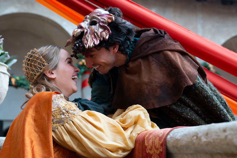Romeo and Juliet smiling at each other over a balcony