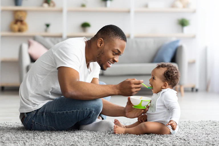 Father feeding baby