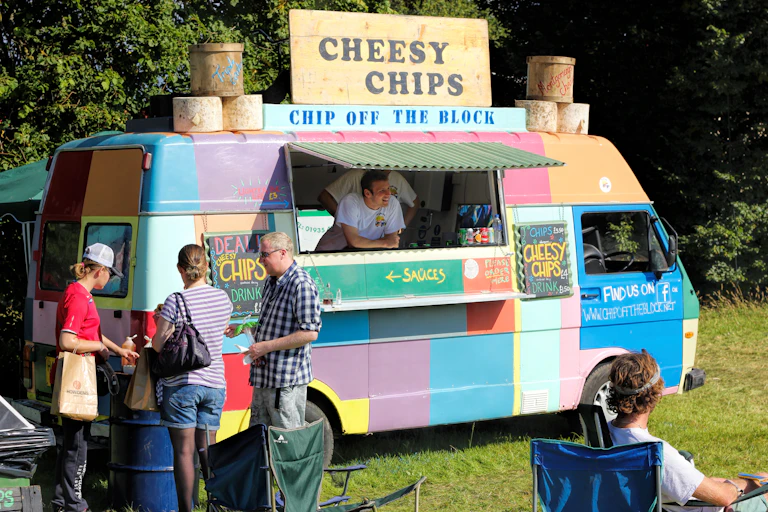 multi-coloured mobile chip van serving customers.