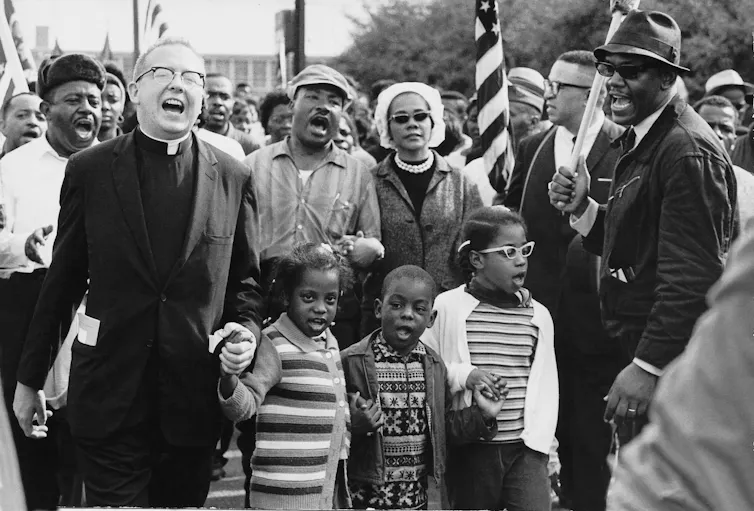 Martin Luther King Jr among a group of chanting protestors.