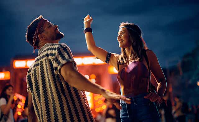 Two people dancing at a festival
