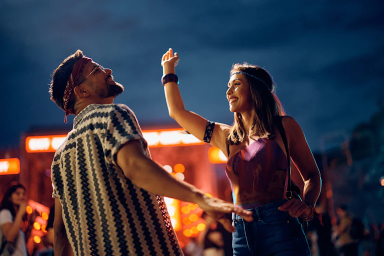 Two people dancing at a festival