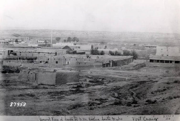 A historic image of a fort, which looks like a collection of buildings.