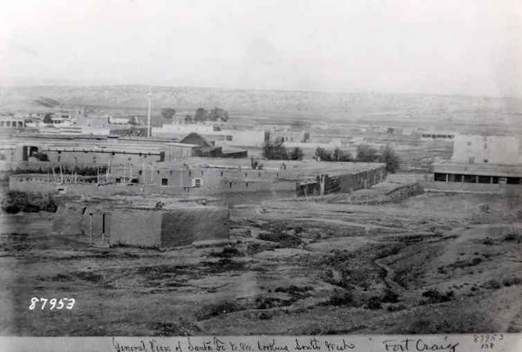 A historic image of a fort, which looks like a collection of buildings.
