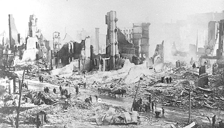 An illustrated black-and-white photo of destroyed buildings.