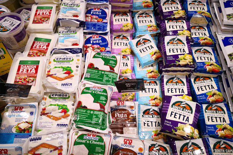 Various type of cheese and milk product on shelf in supermarket.