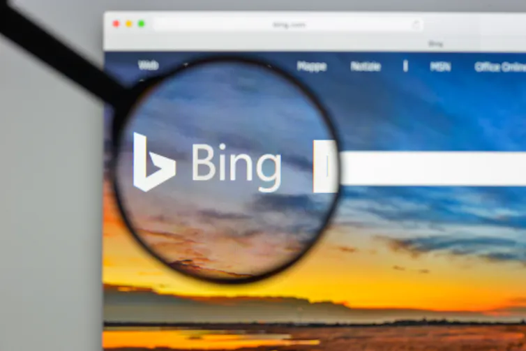 A magnifying glass held over an internet search bar.