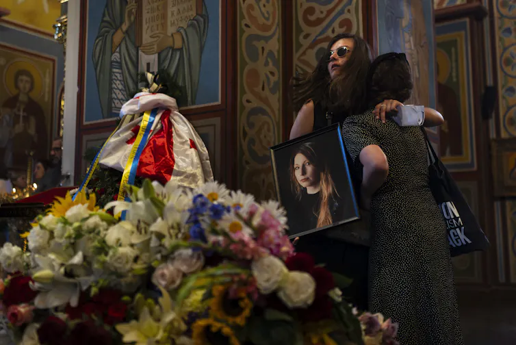 Mourners embrace at Amelina's memorial service.