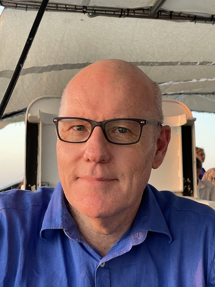 Headshot of John Lyons.