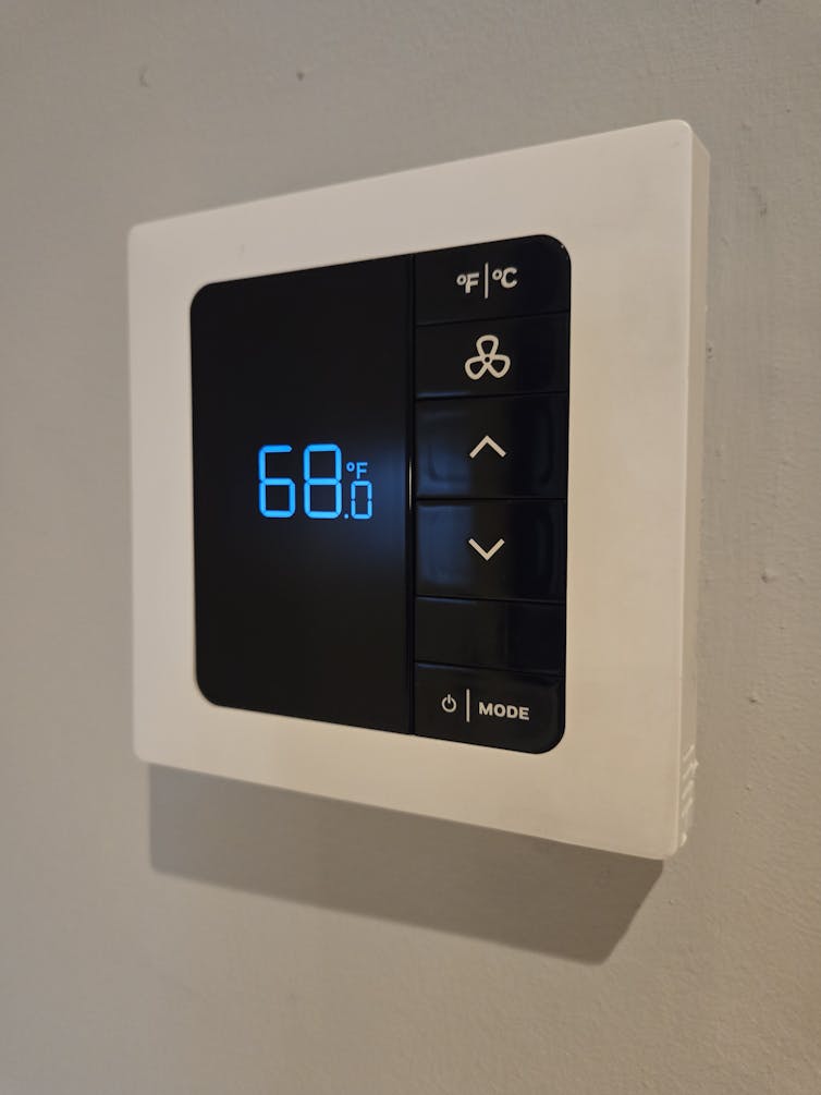 A smart thermostat on a wall.