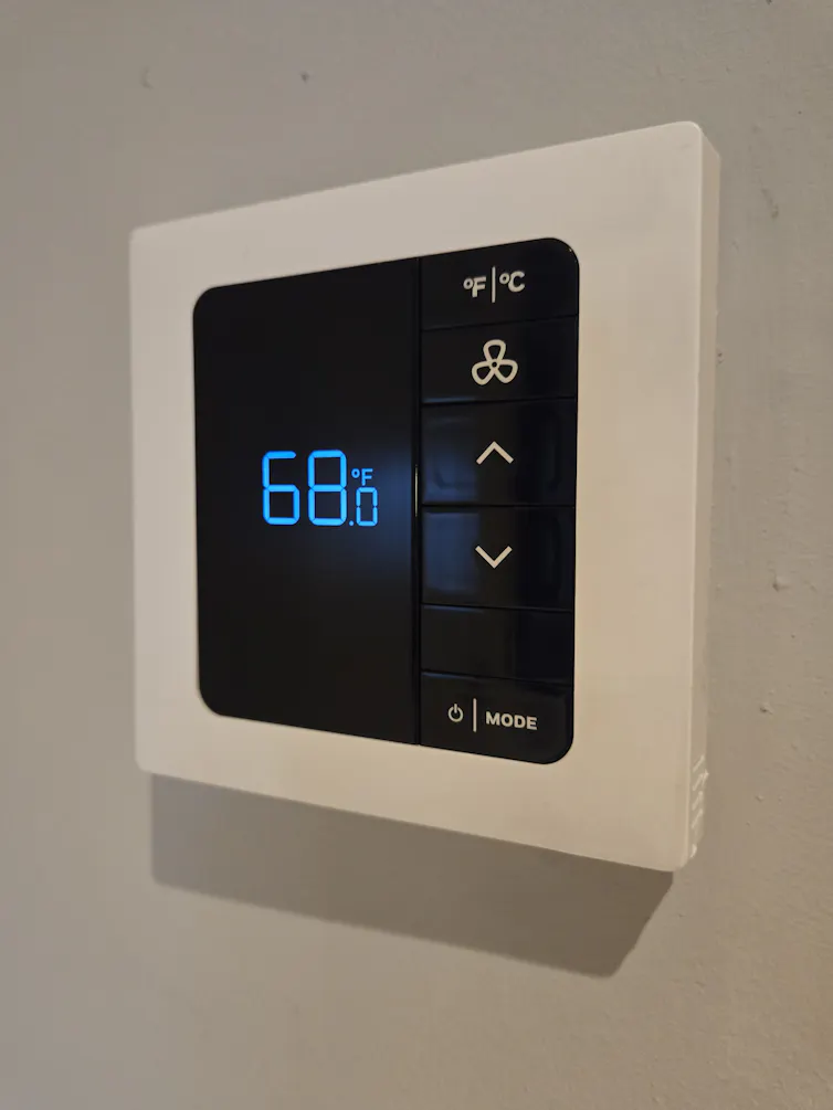 A smart thermostat on a wall.