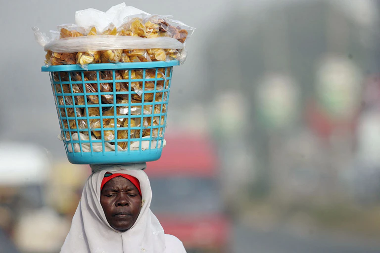 A woman carrying a large basket on her head