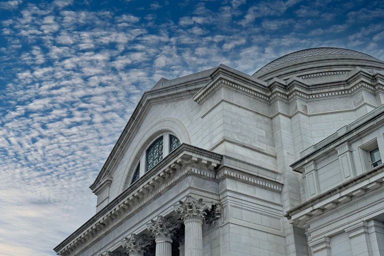 An old stone building shown against a cloudy sky