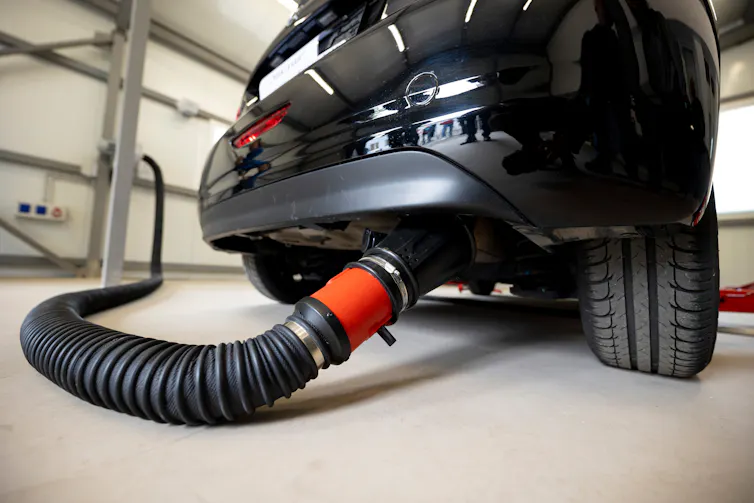 car with hose on exhaust, emissions test.
