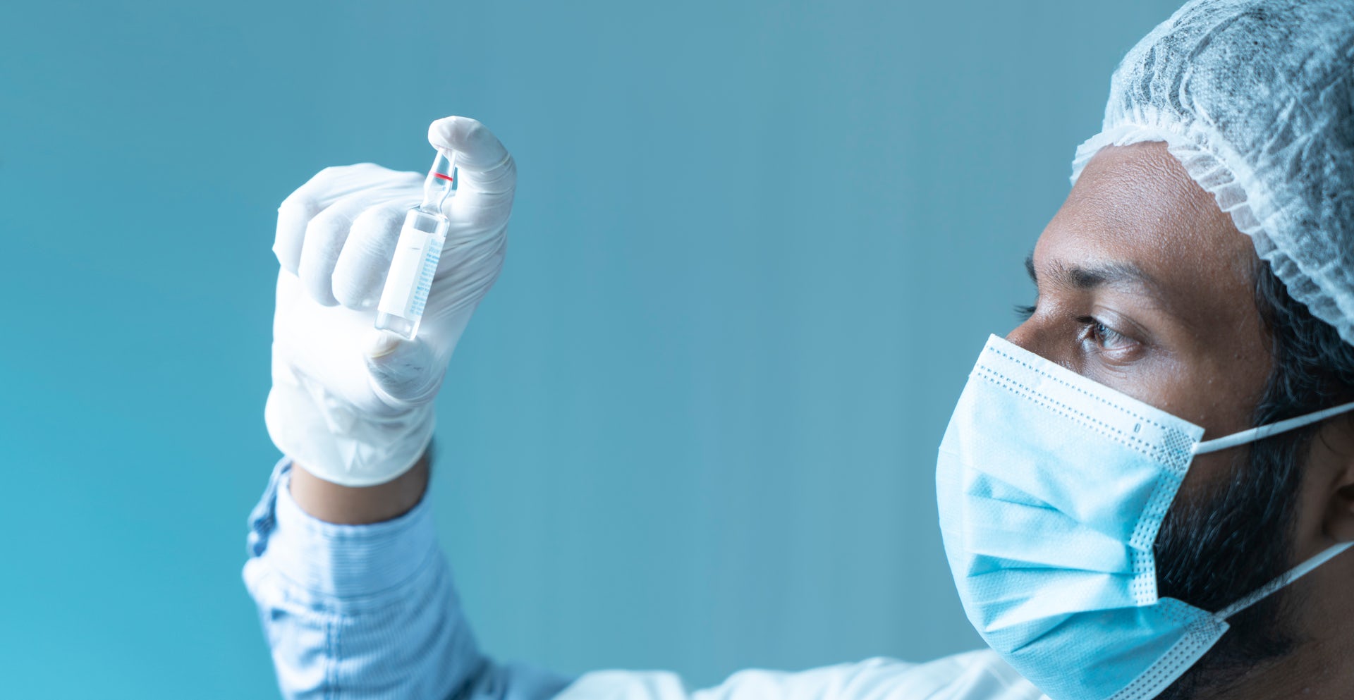 A scientist holds a vial of the M72 TB vaccine.