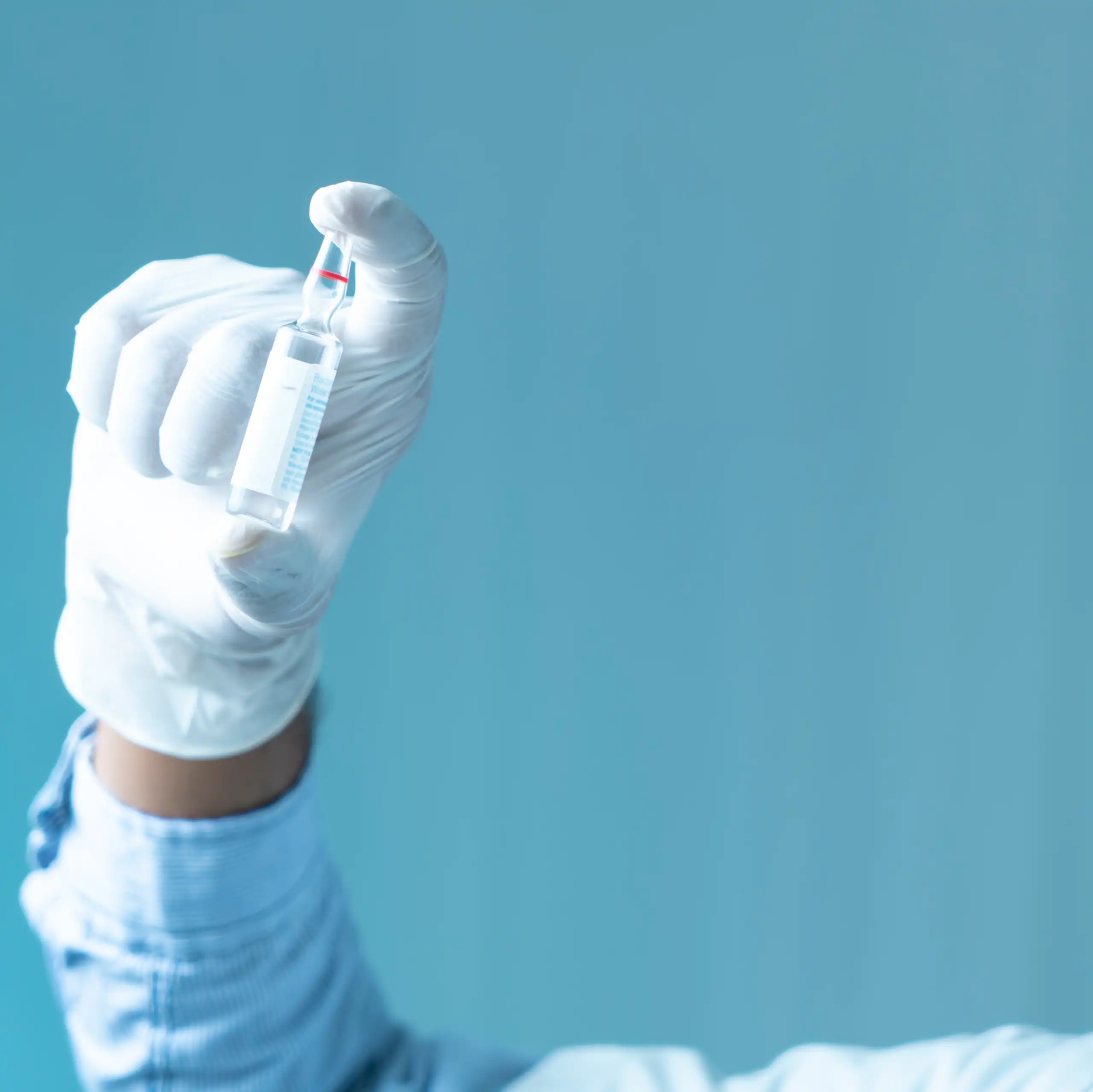 A scientist holds a vial of the M72 TB vaccine.
