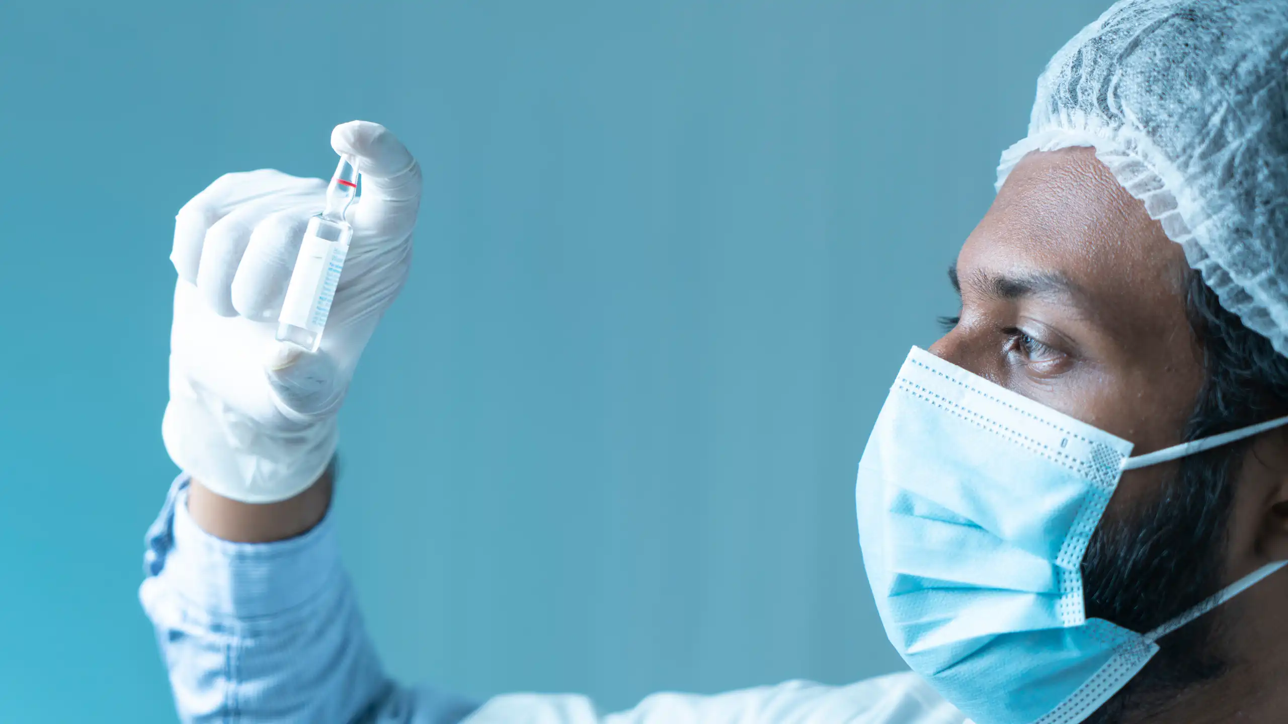 A scientist holds a vial of the M72 TB vaccine.