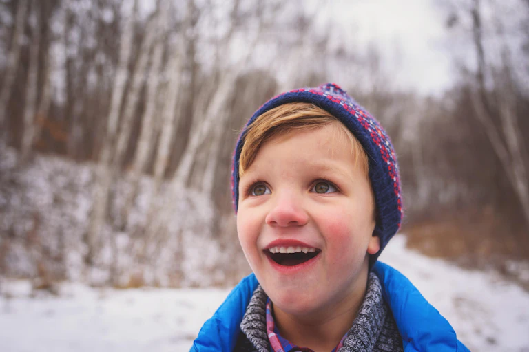 A small sweet-faced boy looking up at something in pure wonder.